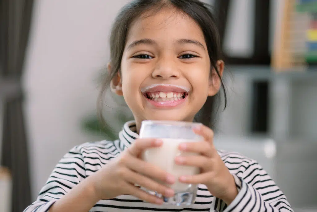 Cute girl drinking milk -Calcium Rich Foods